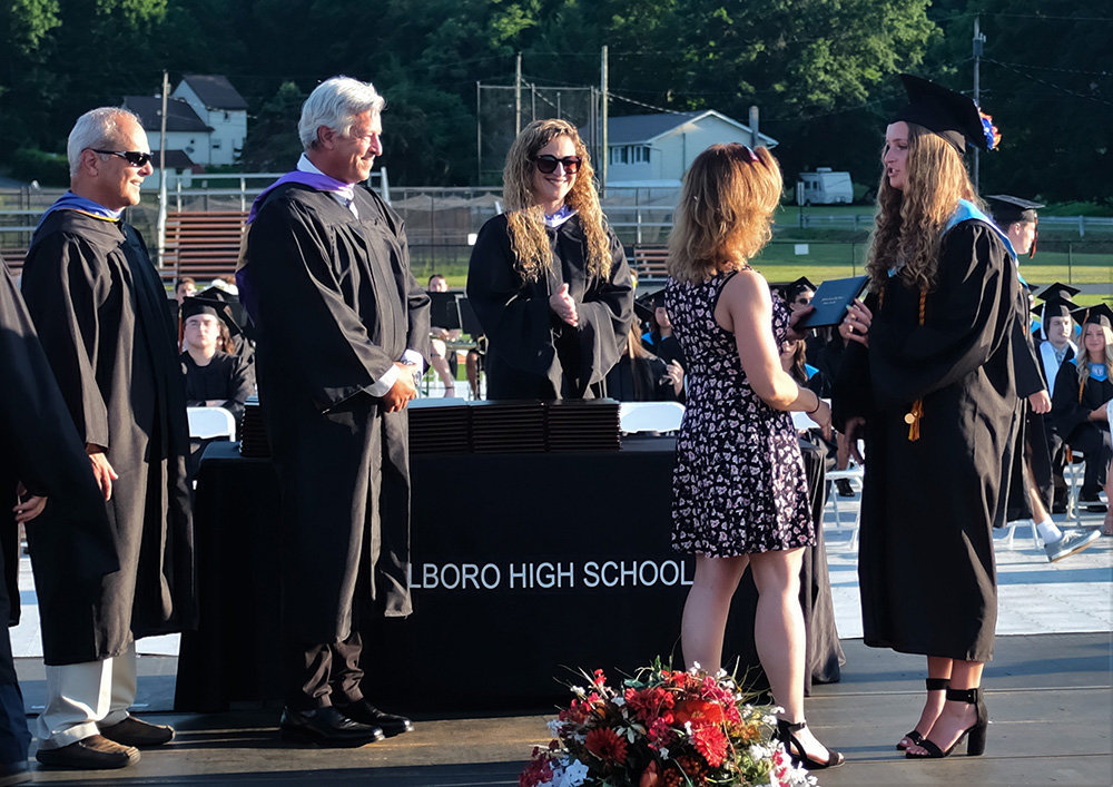 Salutatorian Emma Schlagler receives her diploma from her mother Carrie